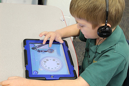 child using tablet in classroom